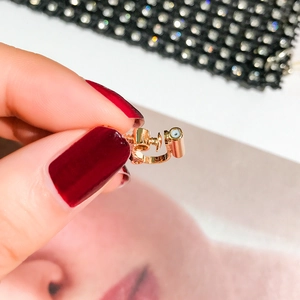 Macro detail of golden screw adjustable earring converter with comfortable soft white pad
