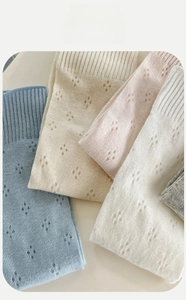 Close-up of pastel cotton socks with breathable hollow knit patterns in macaron colors