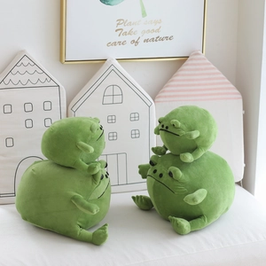 Close-up of soft green frog plush toys in two sizes with high-quality texture