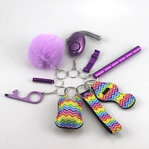 Detail view of purple self-defense keychain set with fluffy ball and personal alarm