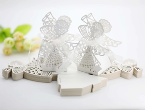 Detailed laser-cut white angel candy gift box with elegant white ribbon and flat packaging