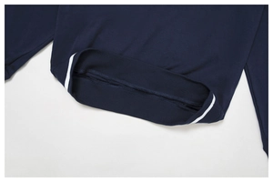 Close-up of navy blue sweatshirt ribbed hem and cuffs with white stripe detail