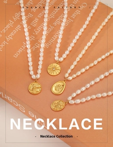 Detailed view of freshwater pearl necklaces with gold coin pendants on warm background