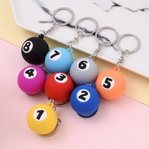 Set of 8 colorful billiard ball keychains with numbers 1 to 8 on a matte surface