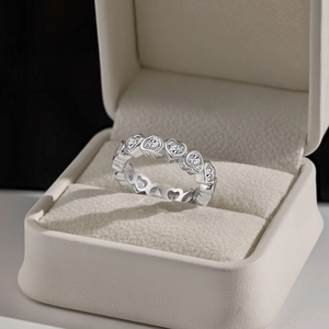 Macro detail of S925 sterling silver heart-cut diamond ring in a luxury beige jewelry box