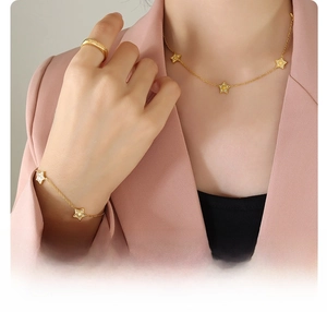 Detail of 18k gold plated surgical titanium steel star necklace and bracelet set on model