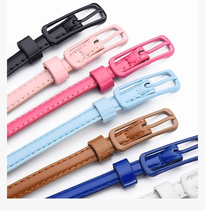 Selection of slim patent leather waist belts in multiple vibrant candy colors with pin buckles
