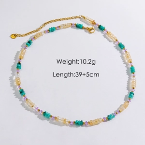 Handmade beaded necklace with natural stones, shell smiley and gold accents on white base