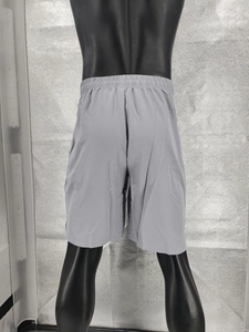 Rear view of grey quick-dry sports shorts showing elastic waistband on a black mannequin