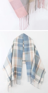 Close-up of pink and grey plaid scarf with fringe detail and soft woven texture