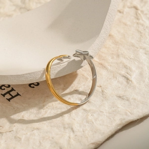 Detail of adjustable star and moon ring in two-tone gold and silver stainless steel