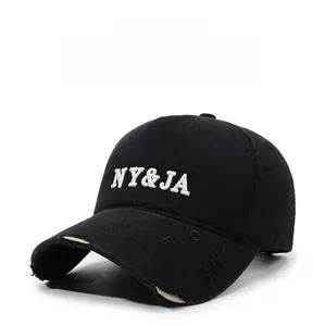 Close-up of black washed baseball cap showing white NY&JA embroidery and distressed brim details