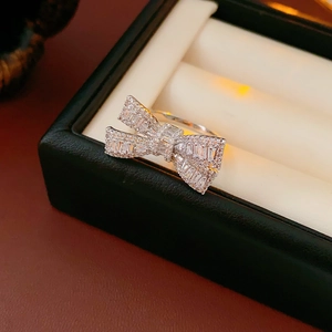 Macro shot of silver bow ring featuring detailed pavé cubic zirconia settings