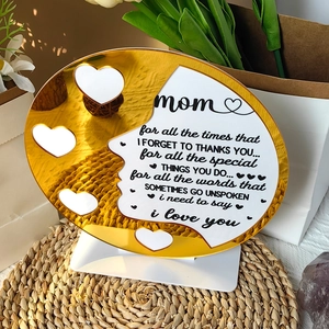 Detail of gold mirror acrylic Mother's Day plaque with white base and heart cutout patterns