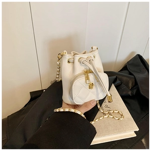 Detail of white PU leather mini bucket bag with chain strap and flower zip puller