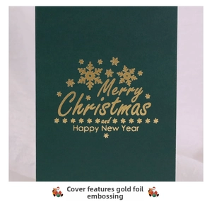 Detailed view of dark green Christmas card with gold foil snowflakes and Merry Christmas text