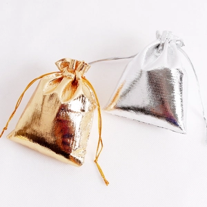 Drawstring jewelry gift bags in shiny metallic gold and silver coated fabric