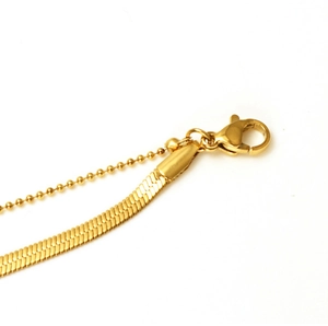 Detail of 18K gold plated titanium snake chain anklet with lobster clasp and bead extender