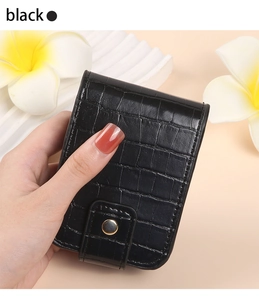 Close-up of black crocodile pattern PU leather lipstick pouch with gold snap button