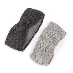 Detail of grey knitted headbands showing thick fleece lining and cable knit texture