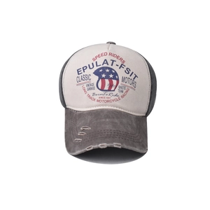 Detail of distressed brim and vintage motorcycle print on washed denim baseball cap