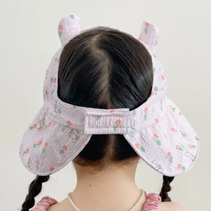 Detail of pink floral sun visor with rabbit ears and adjustable velcro closure for kids