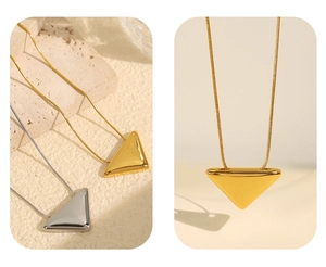 Detail of minimalist gold and silver triangular pendant necklaces with fine snake chain link