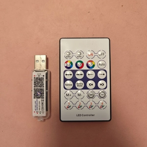 Macro shot of RGB LED controller with USB receiver and remote for smart lighting control