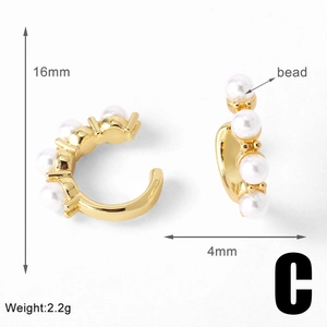 Macro view of 18k gold-plated C-shaped ear cuff with pearls and zircon details