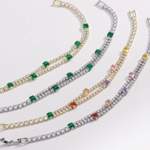 Close-up of double-layered tennis bracelets with colorful zircon stones in gold and silver