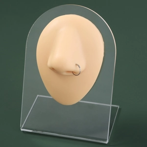 Detailed view of silver U-shaped stainless steel nose ring on professional silicone display