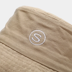 Khaki cotton bucket hat with white 'S' embroidery detail and premium twill texture