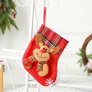 Red Christmas stocking with reindeer plush and plaid trim for holiday tree decoration