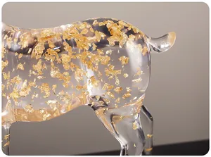 Close-up of luxury transparent elk figurine with delicate gold foil flakes inside