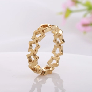 Macro view of gold-plated titanium steel ring with hollow star cutout patterns