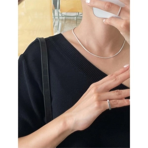 Close-up of elegant 925 sterling silver zircon necklace and rings on a model