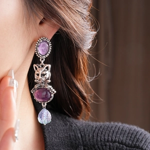 Vintage style drop earrings featuring purple stones and cat relief in antique silver finish