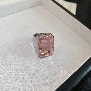 Macro shot of a large rectangular pink gemstone ring set in a silver band in a jewelry box