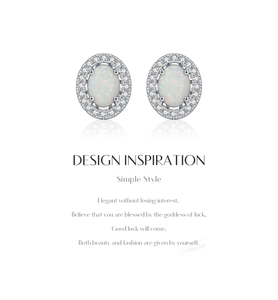 Macro shot of silver oval opal stud earrings with a halo of small zircon crystals