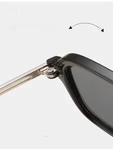 Detail of durable gold metal hinge on black square frame sunglasses for smooth folding