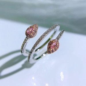 Macro detail of silver snake ring featuring teardrop pink stones and rose gold accents