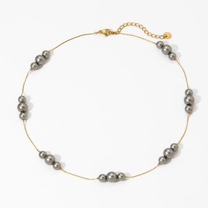 Elegant gold pearl necklace with dark grey pearls and lobster clasp on white background