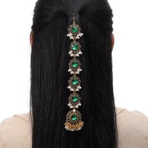 Rear view of model wearing a vintage gold head chain with green gems and white pearls