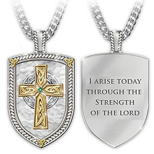 Detail of shield pendant with Celtic cross, green gem, and religious engraving on back