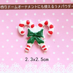 Detailed close-up of a Christmas candy cane resin charm with red stripes and green bow