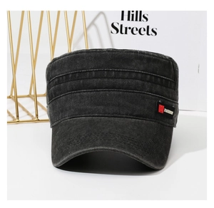 Detail of black washed denim army cap featuring a fashion label on the side panel