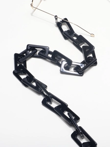 Detail showing high-quality black acrylic rectangular chain links for eyewear fashion