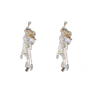 Baroque tassel earrings with silver needle, zirconia bow, and pearls on white background