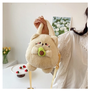 Cute beige cat plush handbag with green avocado accessory and yellow shoulder strap