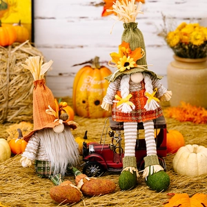 Pair of autumn gnomes with maple leaves and straw hats for Thanksgiving home decoration